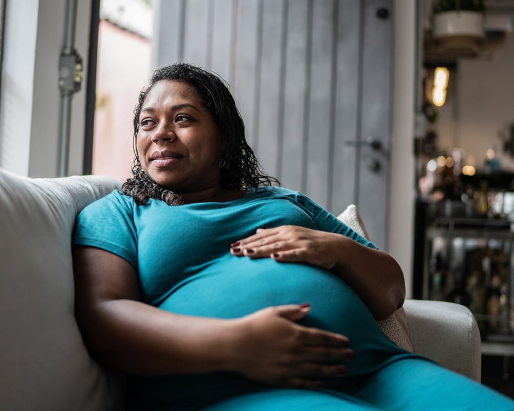 a woman in a blue shirt sitting on a chair
